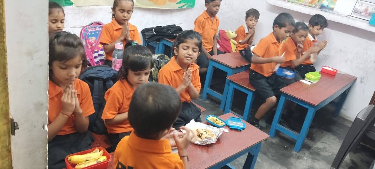Vidhya Peeth children praying together before their lunch meal
